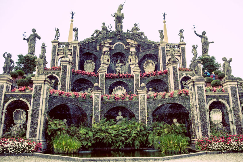 beautiful castle with pink flowers and sculptures 