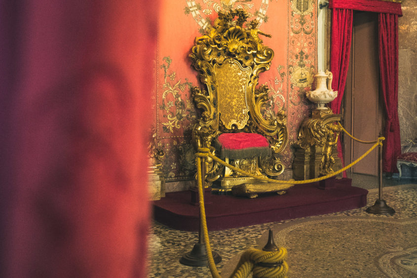 velvet red curtain and gold king's throne chair
