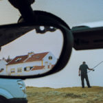car mirror with house, truck and man finishing