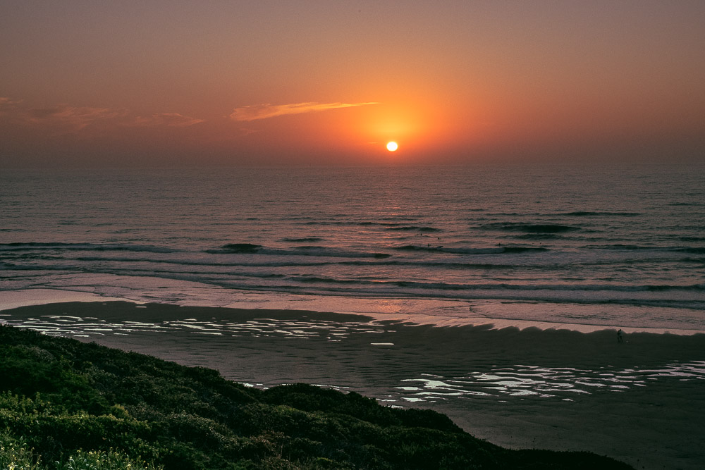 beautiful orange sunset with ocean waves and coast